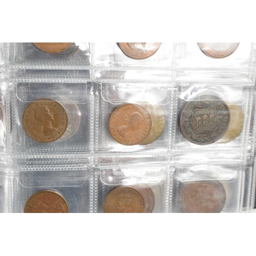 70 - Two albums of GB and worldwide coinage to include Chinese coins, silver coins, George III token, Que... 