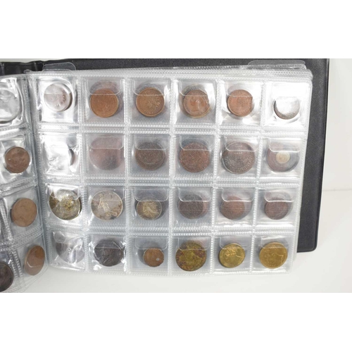 70 - Two albums of GB and worldwide coinage to include Chinese coins, silver coins, George III token, Que... 