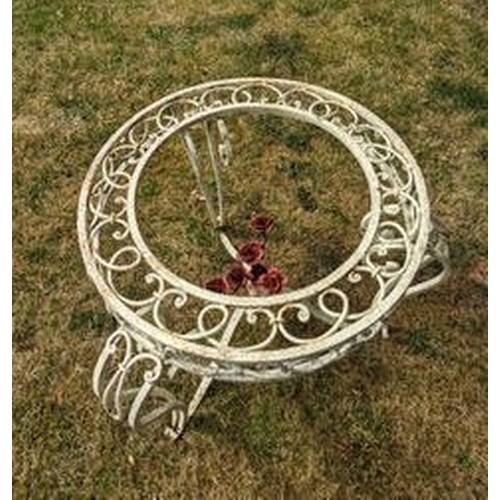 521 - A pair of fin-de-siecle cast iron garden chairs, with wrought iron roses, the frame painted cream wi... 