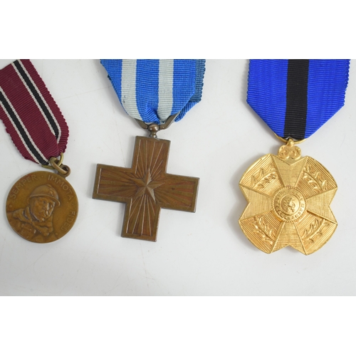 13 - A group of medals to include the Croix De Guerre with palm spray, Order of Polonia Restitua 1944, It... 