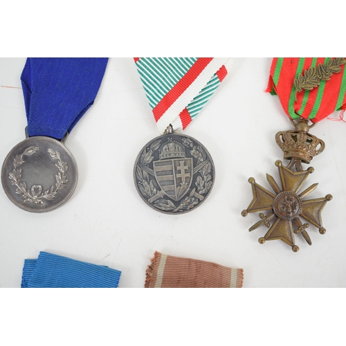 13 - A group of medals to include the Croix De Guerre with palm spray, Order of Polonia Restitua 1944, It... 