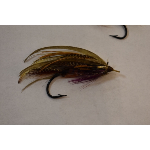 253 - Fishing Interest: two Edwardian salmon flies, together with a pair of similar vintage folding specta... 