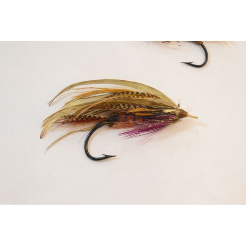 253 - Fishing Interest: two Edwardian salmon flies, together with a pair of similar vintage folding specta... 