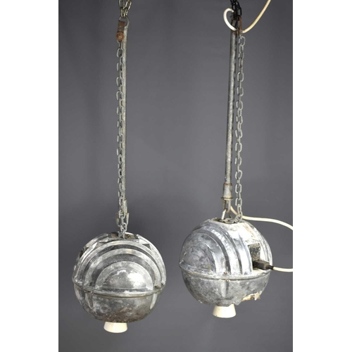 140 - A pair of vintage industrial cast aluminium ceiling lights of spherical globe form, 28cm diameter.