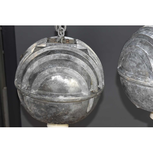 140 - A pair of vintage industrial cast aluminium ceiling lights of spherical globe form, 28cm diameter.