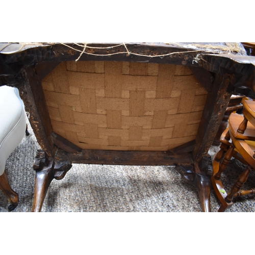 568 - An 18th century and later walnut framed armchair, lacking upholstery, the wide carved arms adjoining... 