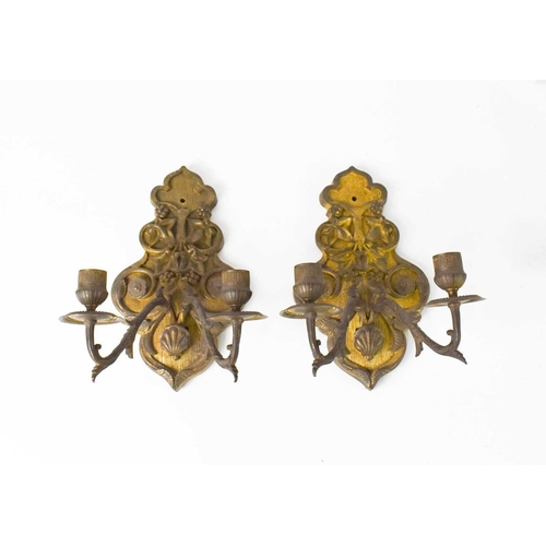 104 - A pair of gilt metal French 19th century wall sconces, the cast embossed backplates emanating twin b... 