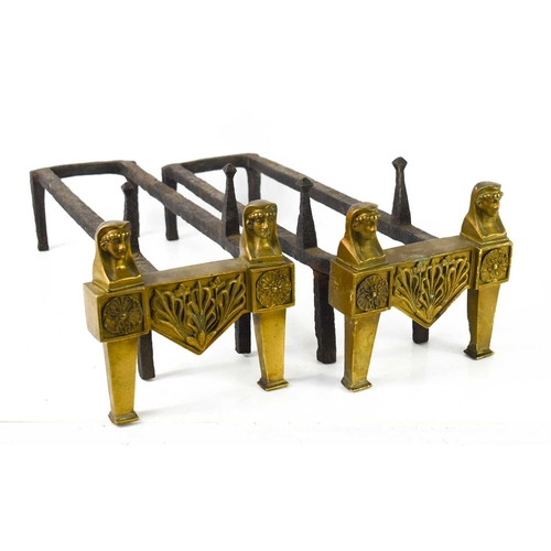 105 - A pair of Egyptian revival brass and iron andirons, each having two face masks above rosettes, 18cm ... 