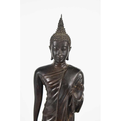 109 - A late 19th / early 20th century bronzed metal Thai Buddha figure, raised on a decoratively cast bas... 