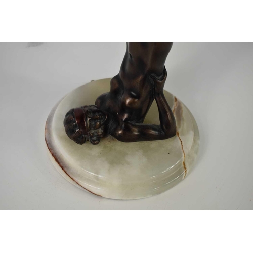 113 - An Art Deco bronze style lamp base in the form of a nude woman, with onyx base, 31cm high.
