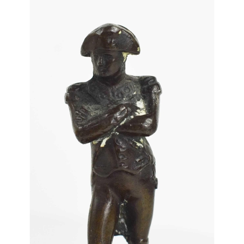 115 - A bronze figure of Napoleon, 19th century, raised on an associated wooden and cast metal base, Napol... 