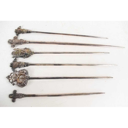 125 - A group of six silver plated meat skewers of various design, from the Grand Hotel in Eastbourne.