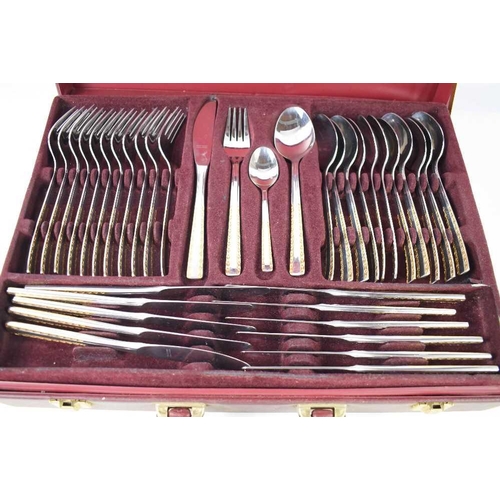 127 - A Solingen of Germany canteen of cutlery, 18/10, in a red leather suitcase with two layers.