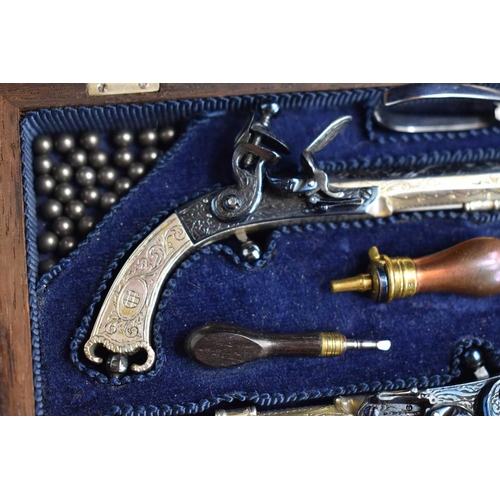 13 - A fine pair of Peter Dyson and Sons replica miniature flintlock pistols together with accessories in... 