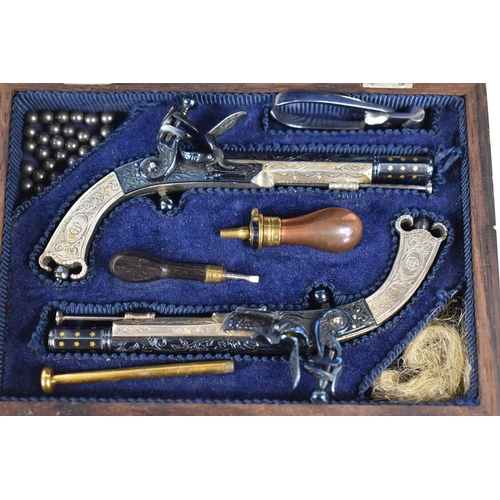 13 - A fine pair of Peter Dyson and Sons replica miniature flintlock pistols together with accessories in... 