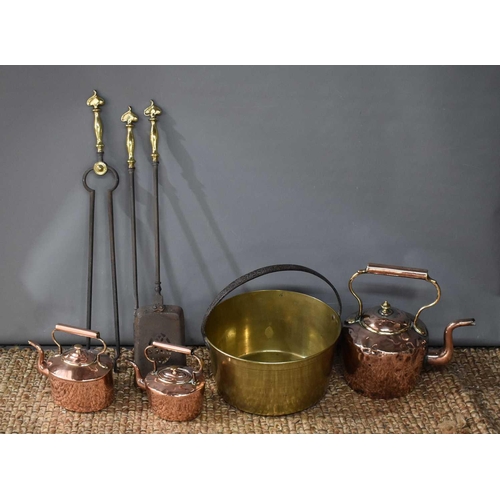 143 - A 19th century brass jam pan together with three copper kettles and a fireside companion set, circa ... 