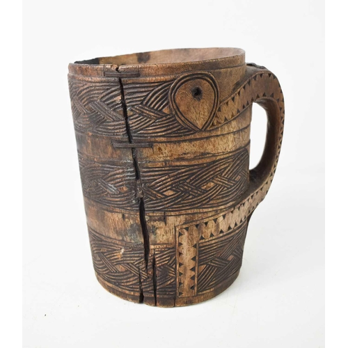 161 - A 19th century treen tankard of large proportions, possibly Norwegian, carved with ropetwist decorat... 