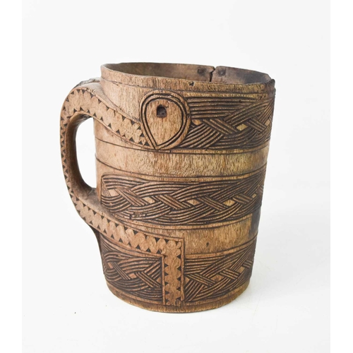 161 - A 19th century treen tankard of large proportions, possibly Norwegian, carved with ropetwist decorat... 