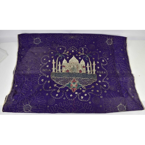 174 - An Indian wall hanging, depicting the Taj Mahal in silvered threads over stumpwork on a purple groun... 
