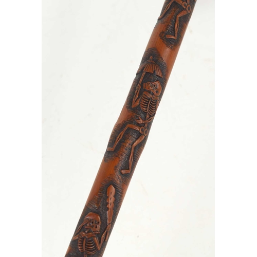 240 - An unusual Japanese bamboo walking stick, relief carved with skeletons and with a crook handle, sign... 