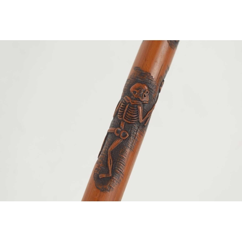 240 - An unusual Japanese bamboo walking stick, relief carved with skeletons and with a crook handle, sign... 