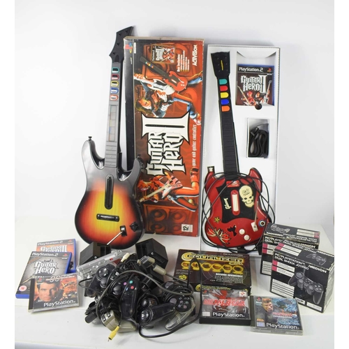 255 - A group of Playstation 1 and 2 games and controllers to include Guitar Hero, Metal Gear solid and ot... 