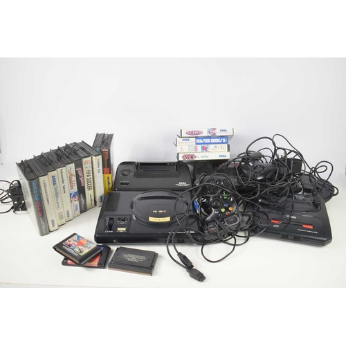 288 - A group of Sega games consoles to comprising of a Master System II and a Mega Drive together with va... 