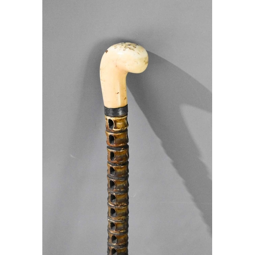 340 - An antique shark spine vertebrae walking cane with curved ball marine ivory handle.