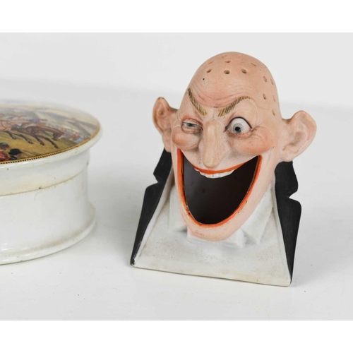 379 - A bisque porcelain ashtray and match holder by Schafer & Vater, 'Ugly Grin'. together with a Prattwa... 