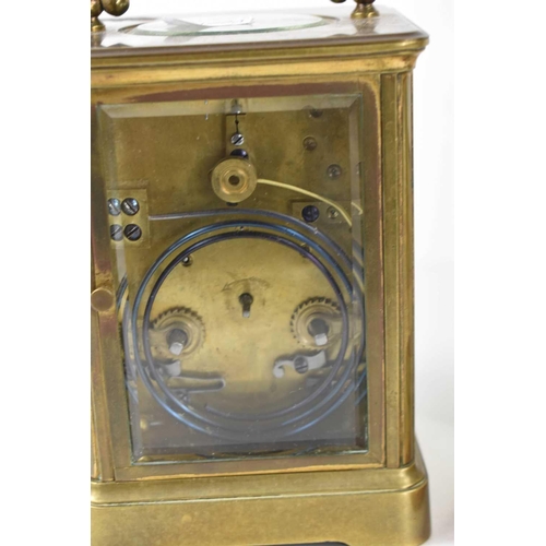 456 - A French brass carriage clock, with Roman numeral dial, and with key, 17cm to top of handle.