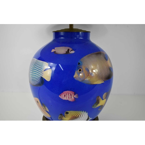 508 - A blue glass lamp base depicting tropical fish, with a large 28 inch cream shade, 63cm high.