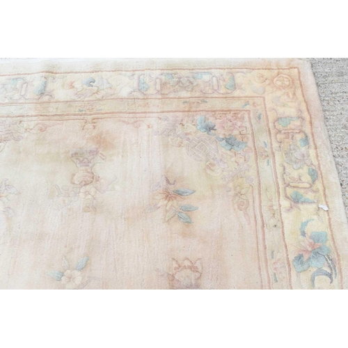 518 - Two Chinese wool rugs, in pastel shades, both with foliate scroll borders, 183cm by 270cm and 156cm ... 