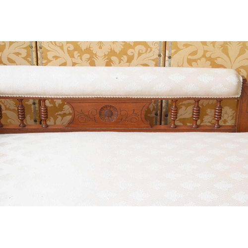 521 - A late Victorian mahogany chaise lounge, the scrolled back carved with floral motif, balustrade supp... 