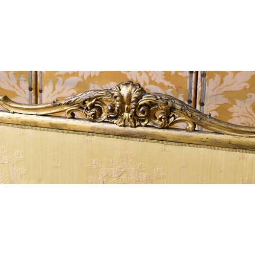 545 - A 19th century country house fire screen, the carved and gilded frame housing a cream upholstered sc... 