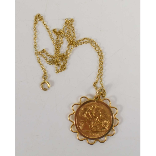 72 - A George V gold half sovereign set in a yellow metal pendant on a 9ct gold chain, 6.46g.