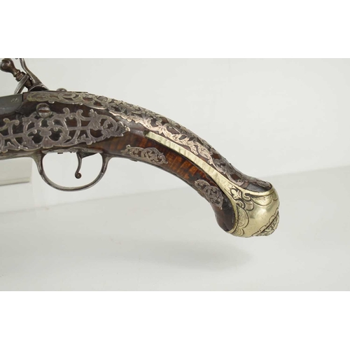 8 - A late 18th century highly decorated flintlock pistol with inlaid silver decoration throughout, the ... 