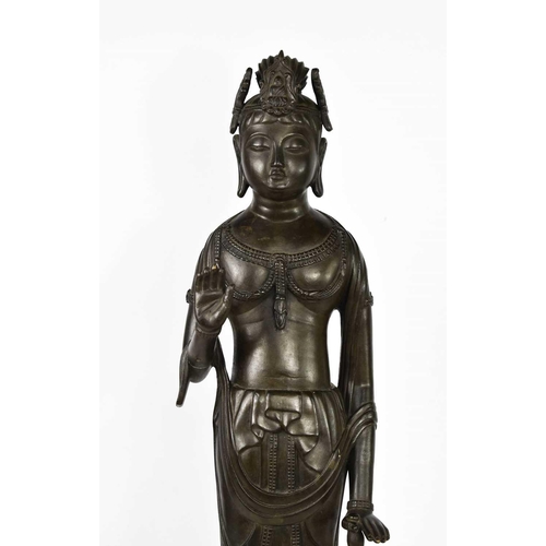 113 - A bronze statue of standing Bodhisattva, raised on a lotus form base, signed verso, 69cm high.