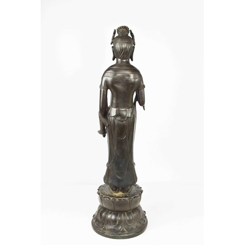 113 - A bronze statue of standing Bodhisattva, raised on a lotus form base, signed verso, 69cm high.