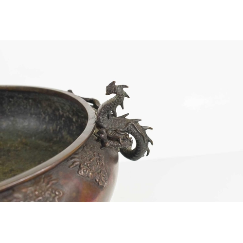 114 - A Chinese bronze censor, circa 1900, modelled with a wrythen dragon clutching the sides of the four ... 