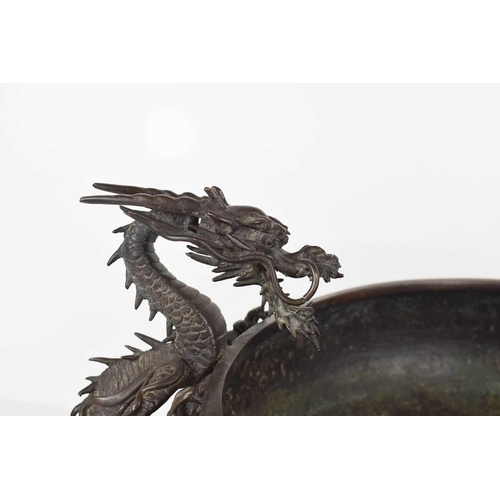 114 - A Chinese bronze censor, circa 1900, modelled with a wrythen dragon clutching the sides of the four ... 