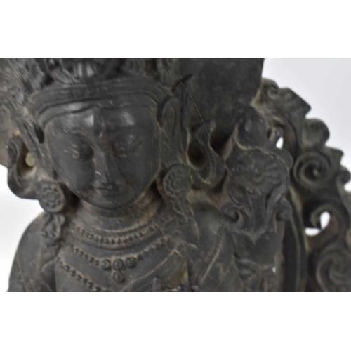 116 - A stone carved Indonesian figure, seated Bodhisattva Avalokiteshvara, the bodhisattva of infinite co... 