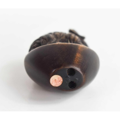 157 - A Japanese carved wooden netsuke of a ram, with glass eyes and signed mother of pearl button to the ... 