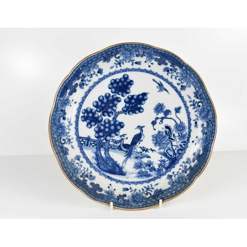 19 - A Chinese blue and white dish, possibly of the Nankin Cargo, with rust coloured wavy edge, depicting... 