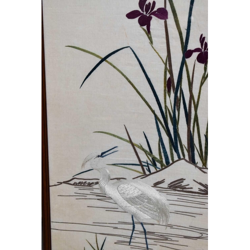 207 - A Chinese silk embroidery depicting crane and bird amidst rushes and irises, 117 by 47cm.