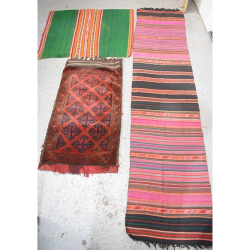 277 - A Middle Eastern hand woven wool sadllebag together with a handmade brightly coloured cotton runner ... 