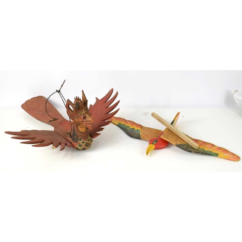 281 - A Balinese carved wooden winged dragon together with a ceiling hanging carved wooden bird with hand ... 