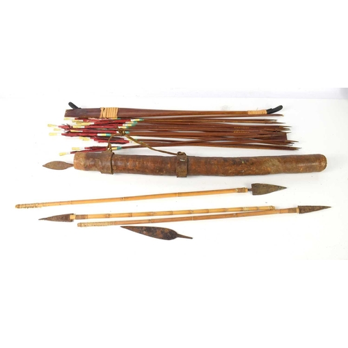 284 - A tribal leather quiver with a quantity of arrows together with a a group of modern arrows.