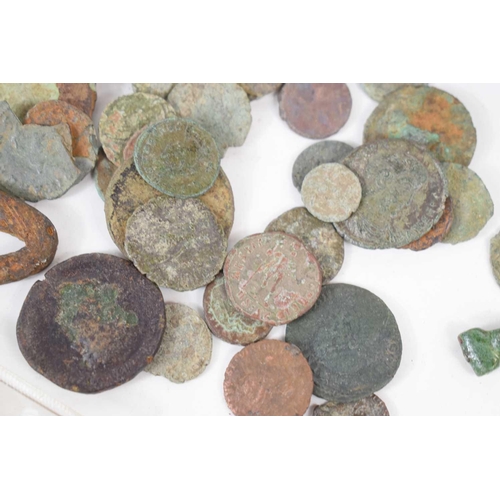 302 - A collection of Roman coins, lead steelyard weights and a group of Roman brooches to include a compl... 