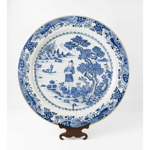 33 - An early 19th century Chinese blue and white charger, depicting a figure standing beside a tree with... 