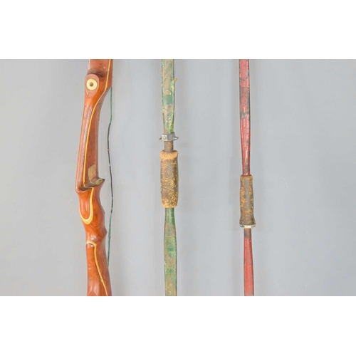 330 - A Pro Hoyt Medallist archery long bow together with two metal longbows.